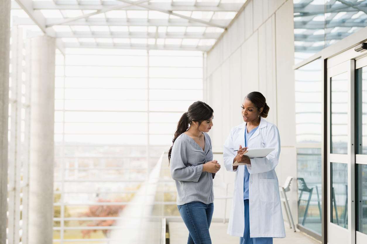 Psychiatrist walking a woman through her test results and explaining why she's eligible for Spravato